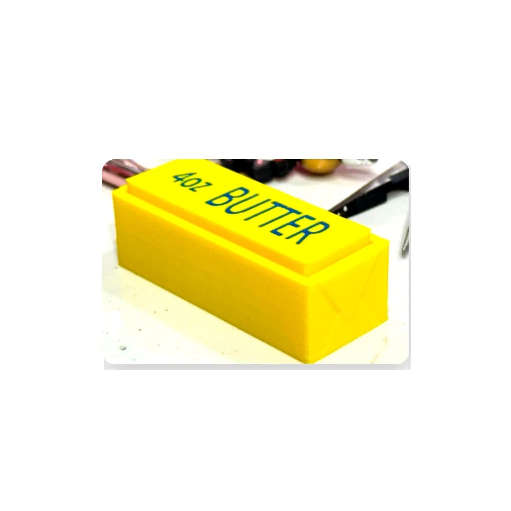 Clean product photo of a yellow Butter Clicker on a white background.