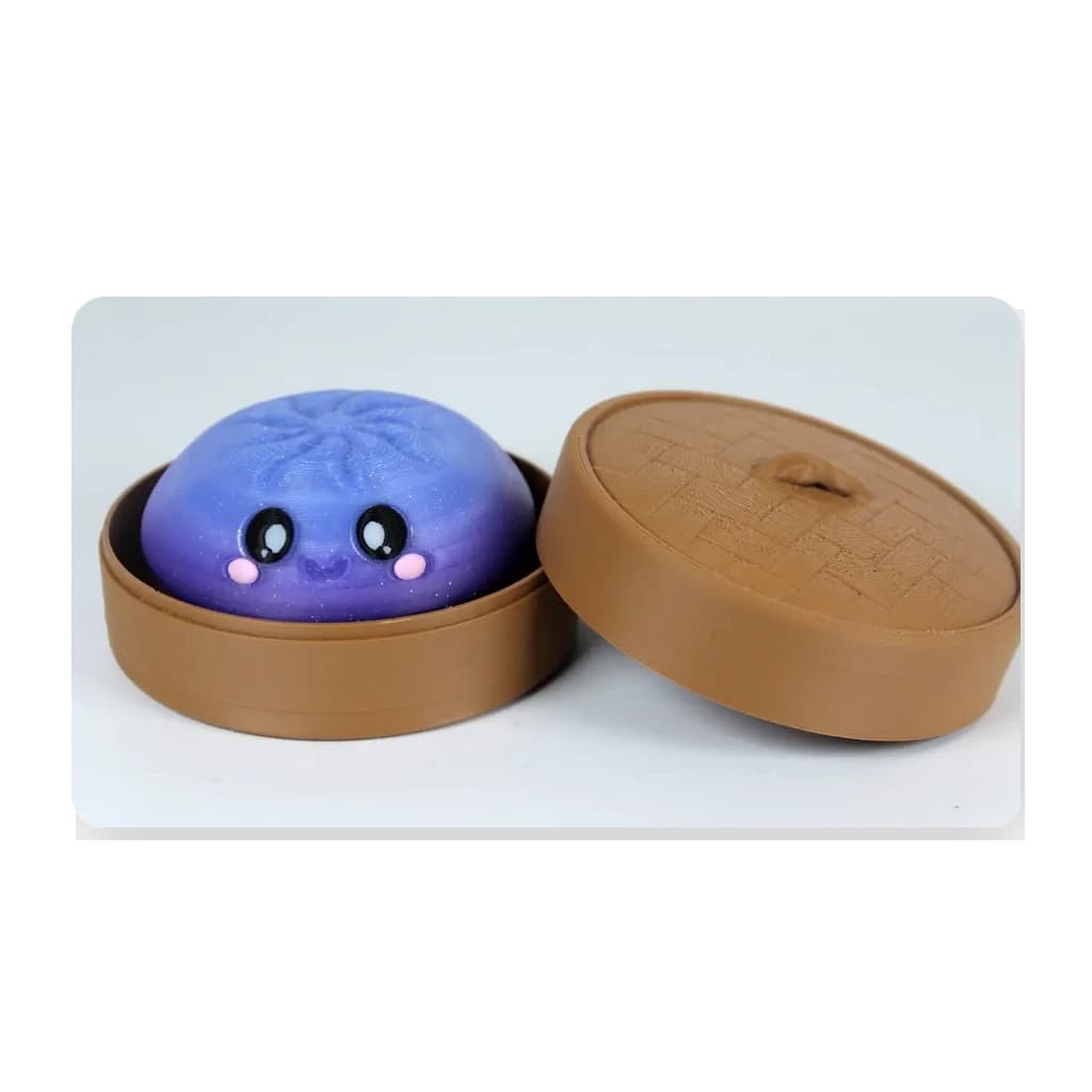 Clean product photo of a purple Dumpling Clicker in a bamboo steamer on a white background.